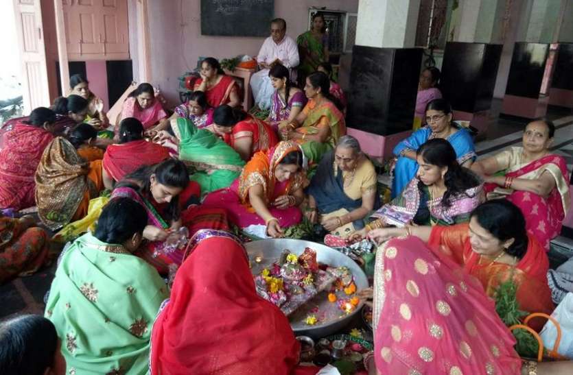 photo पतियों की लंबी उम्र के लिए भूखी-प्यासी रही महिलाएं, की पूजा अर्चना