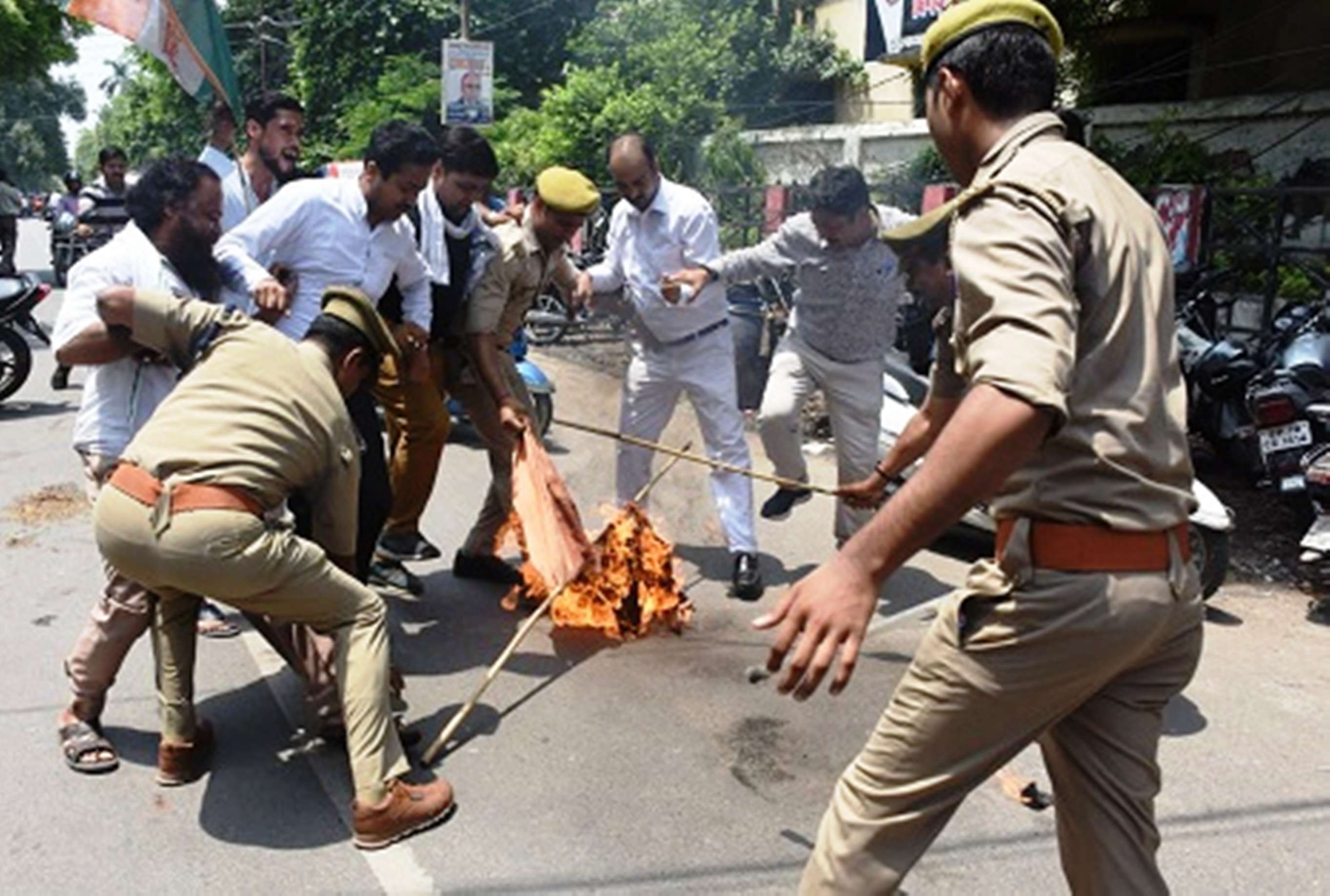 congress workers blow the effigy of up cm yogi adityanath