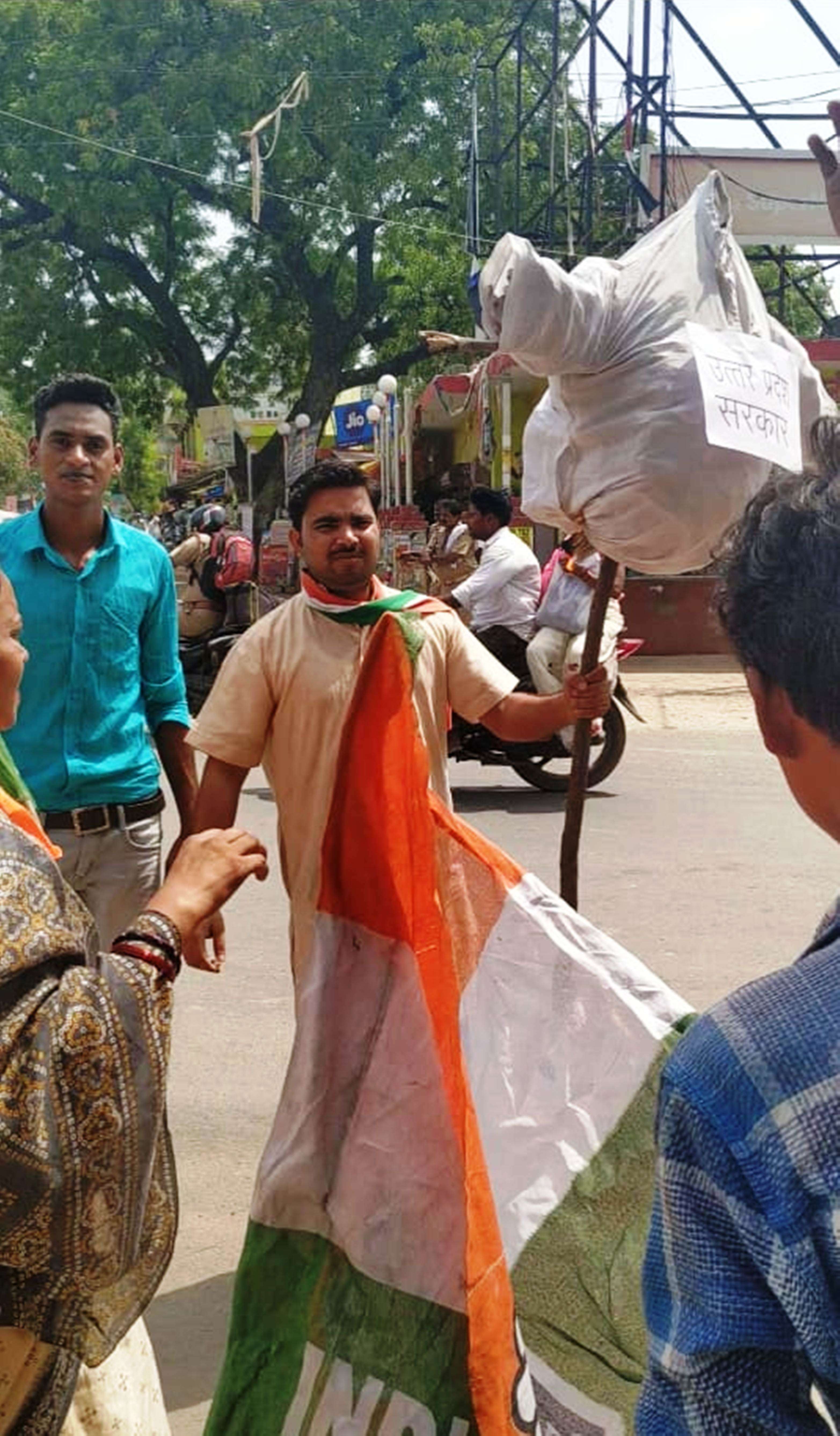congress workers blow the effigy of up cm yogi adityanath