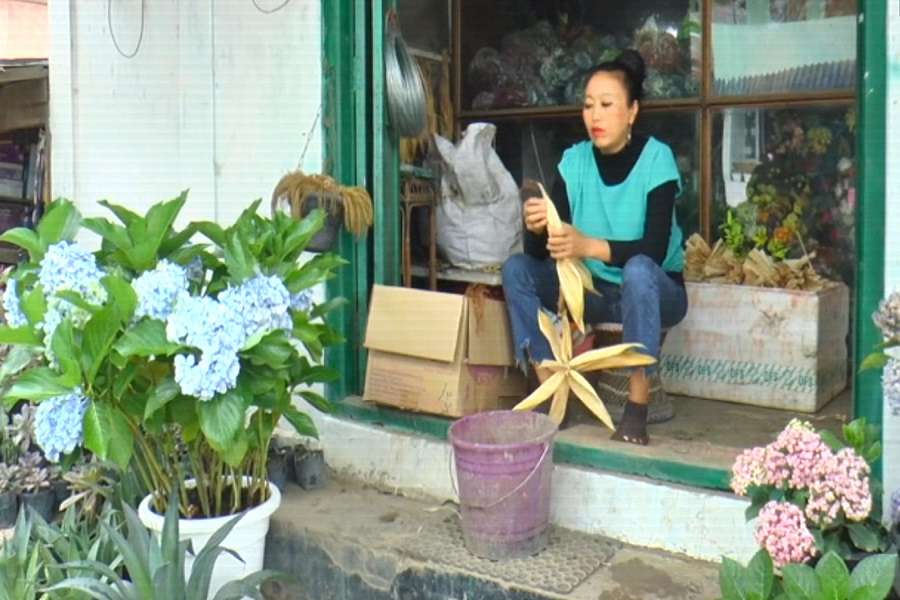 A girl from manipur prepare dolls from corn waste