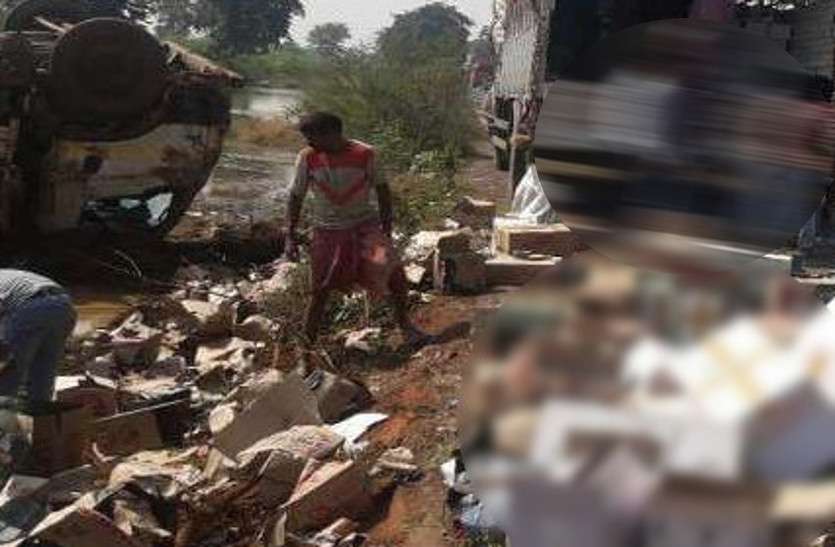 wine_1.jpg शराब से भरा ट्रक पलटा, सड़क पर बिखरी 850 पेटियां