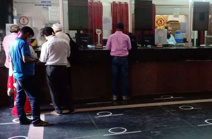 Passengers booking tickets at the reservation counter.
