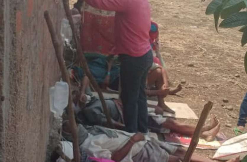 खुले आसमान में लकड़ी की बल्लियों के सहारे चढ़ा रहे सलाइन खुले आसमान में लकड़ी की बल्लियों के सहारे चढ़ा रहे सलाइन