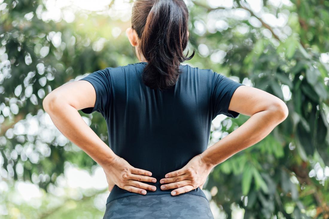 woman-holding-her-back-due-to-lower-back-and-hip-pain.jpg