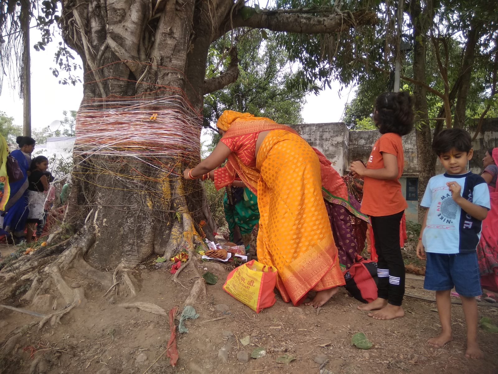 Women circumambulate around this tree, tying a renewable thread and wi