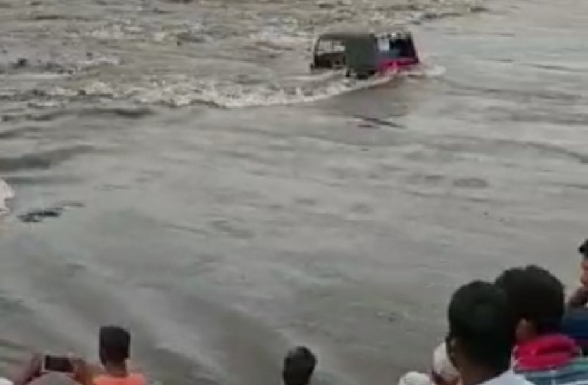 Autos And Bikes Were Swept Away By The Strong Current Of The River